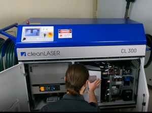 Laser Professional with hands in laser cleaning system performing maintenance