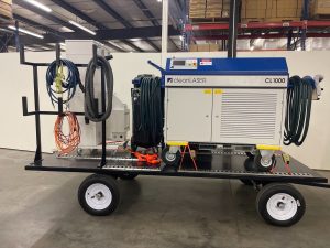 Laser cleaning system on top of a black trailer