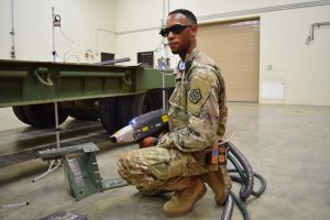 solider holding a laser optic